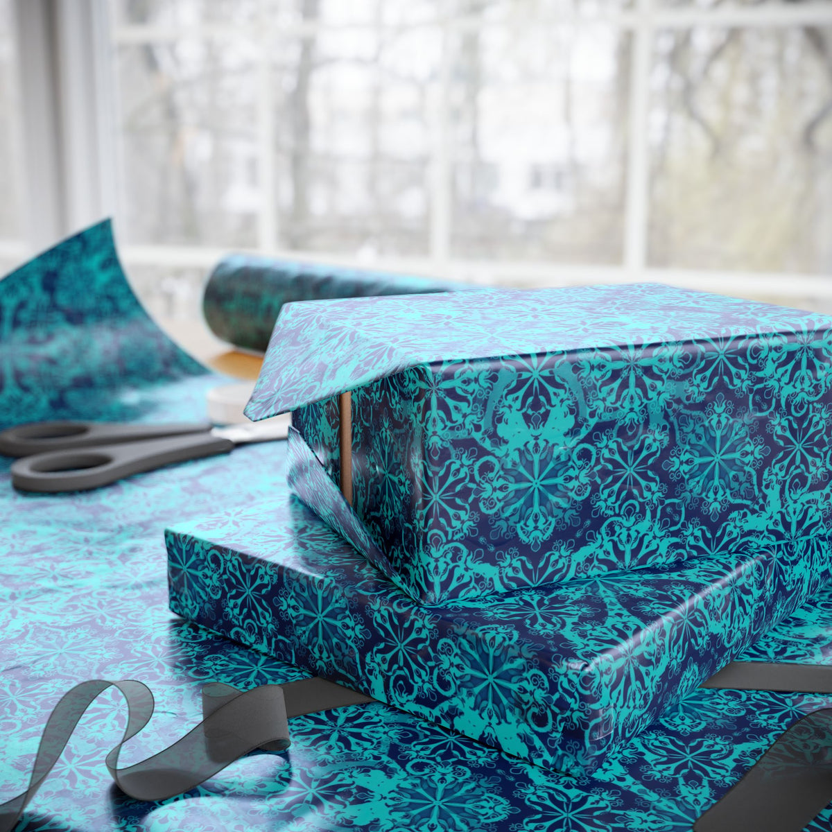 Teal Moroccan tile wrapping paper roll and stacked wrapped gifts with ribbon accents