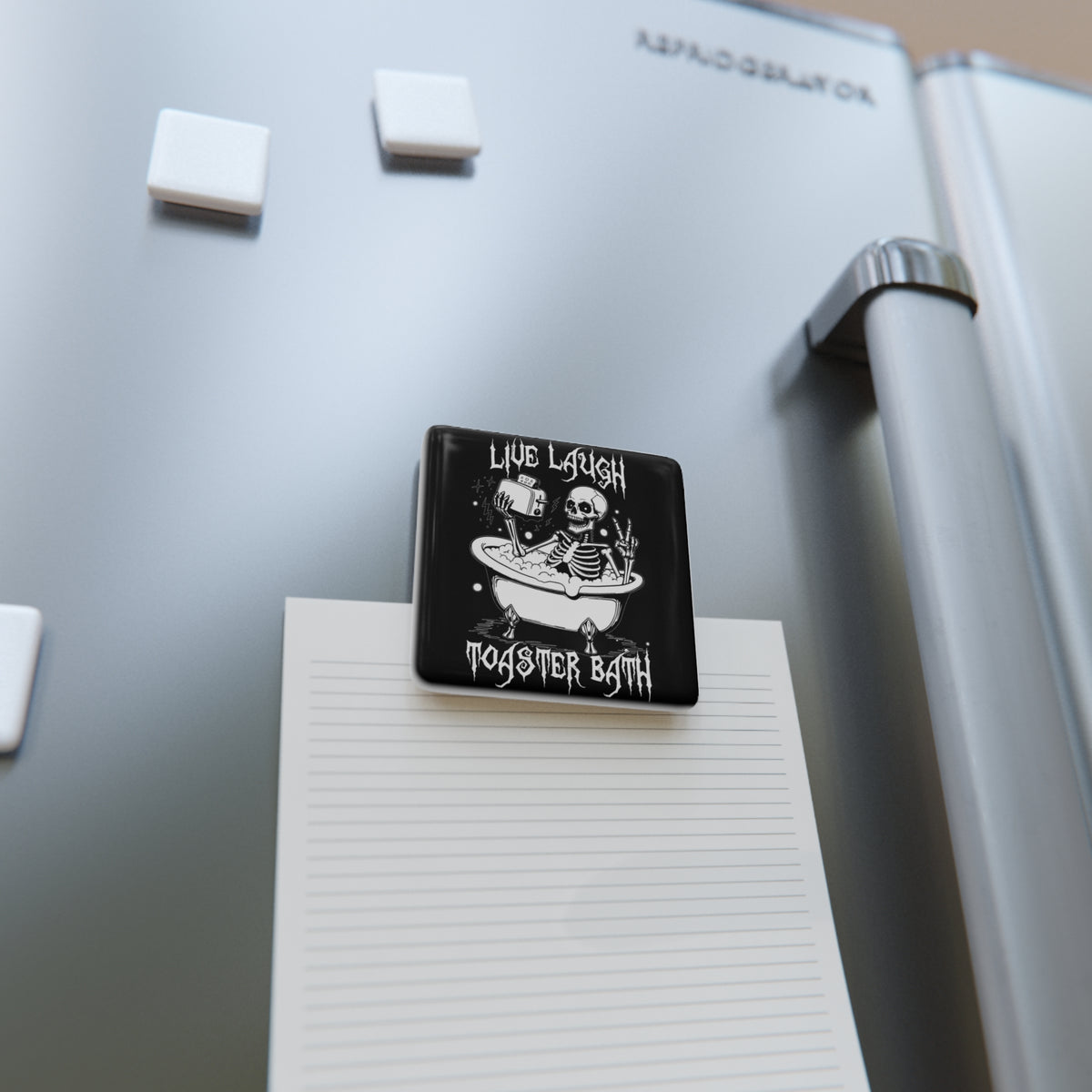 Square black magnet with white skeleton bathtub graphic on notebook paper