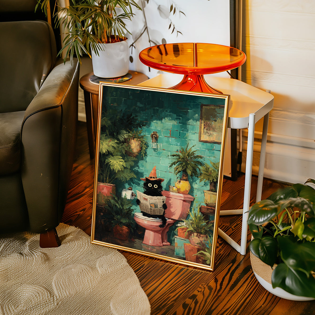 Leaning framed cat artwork with teal garden scene, potted plants, and orange-toned details