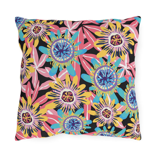 Square decorative pillow with bright multicolor floral abstract print on dark background.