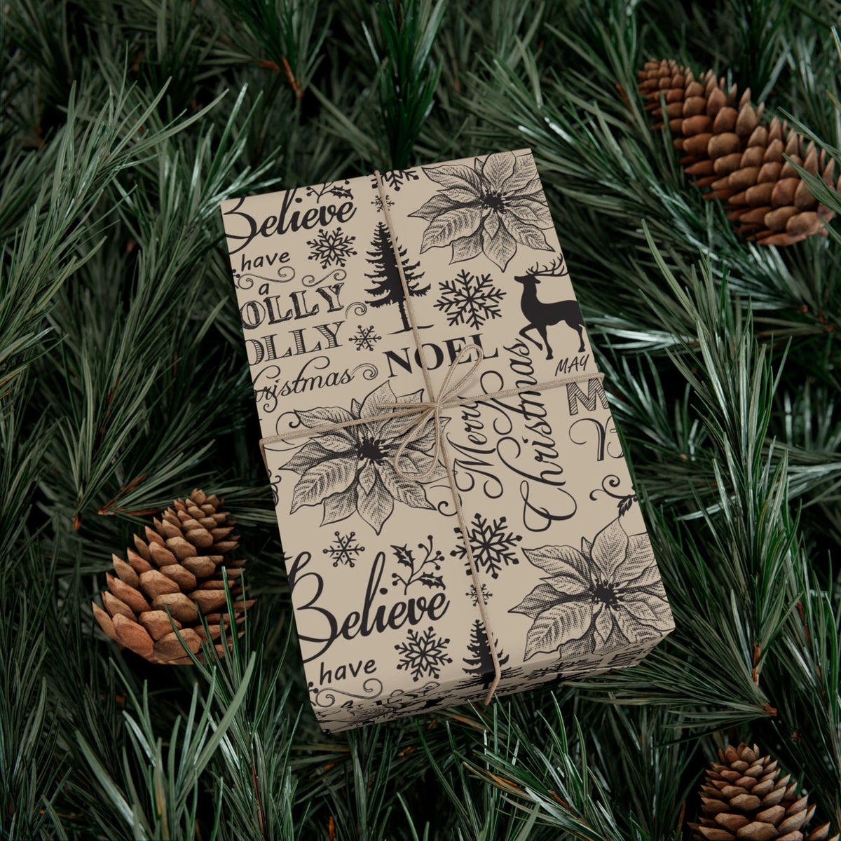 Christmas gift wrap paper, cream with black Believe and Noel lettering, holly, pine, reindeer