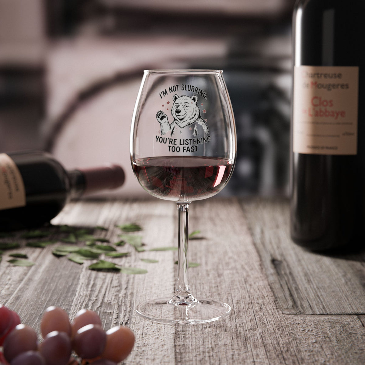 Clear wine glass with bulldog graphic and joke text, filled with red wine