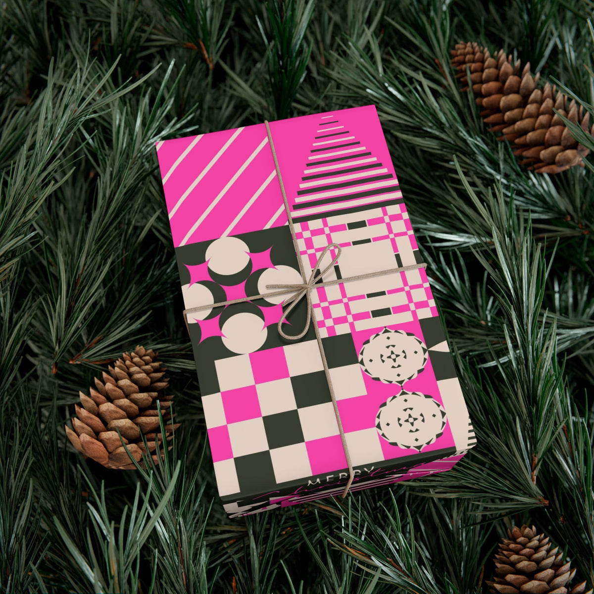 Pink Christmas gift wrap paper with checkerboard patchwork, circles, and pinecone icons
