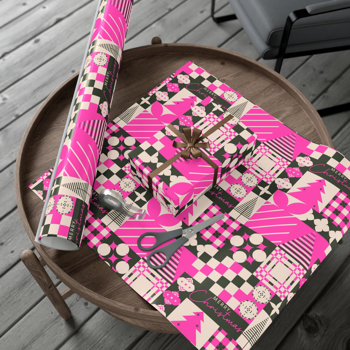 Pink Christmas wrapping paper roll with patchwork plaids, ornaments, and decorative icons