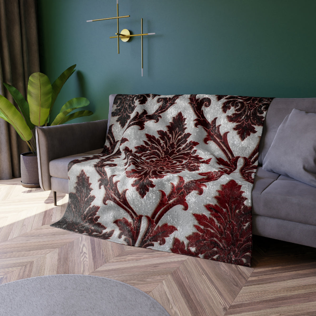 Damask throw blanket on sofa with dark red and ivory ornate floral scroll pattern