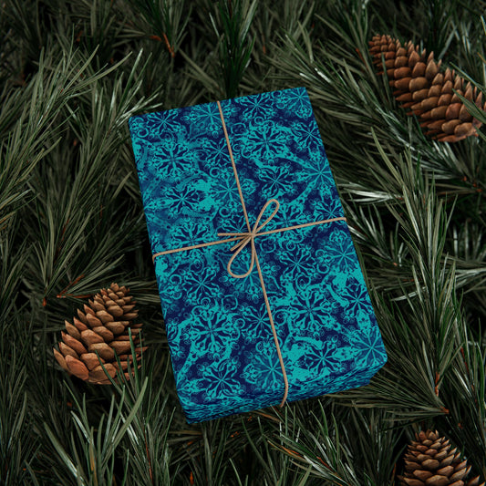 Teal Moroccan tile pattern wrapping paper sheet tied with twine and pine accents, flat lay