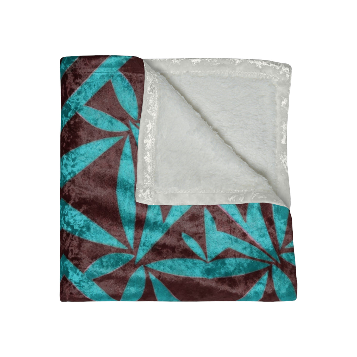 Crushed velvet blanket folded, teal geometric print with cream backing visible