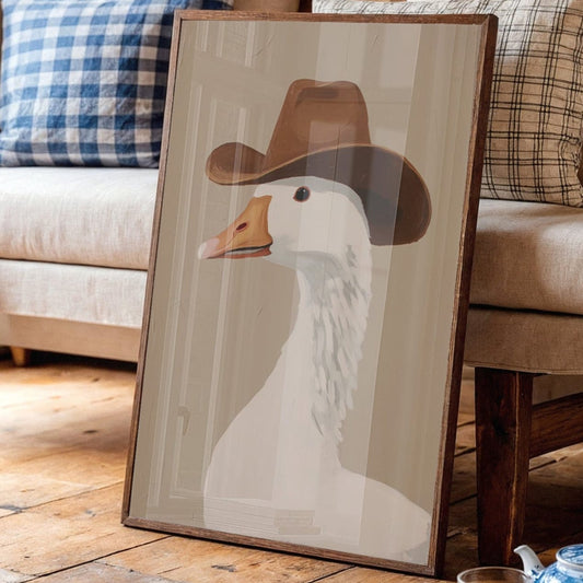 Framed canvas wall art featuring a goose wearing a brown cowboy hat