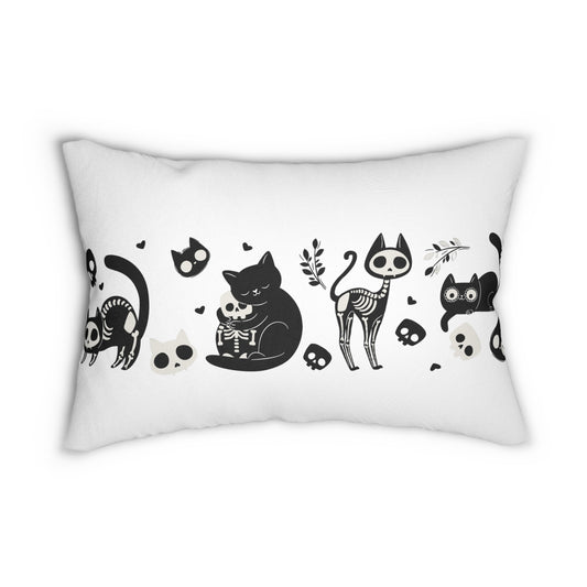 White lumbar pillow front with black skeleton cats, skulls, and paw prints pattern