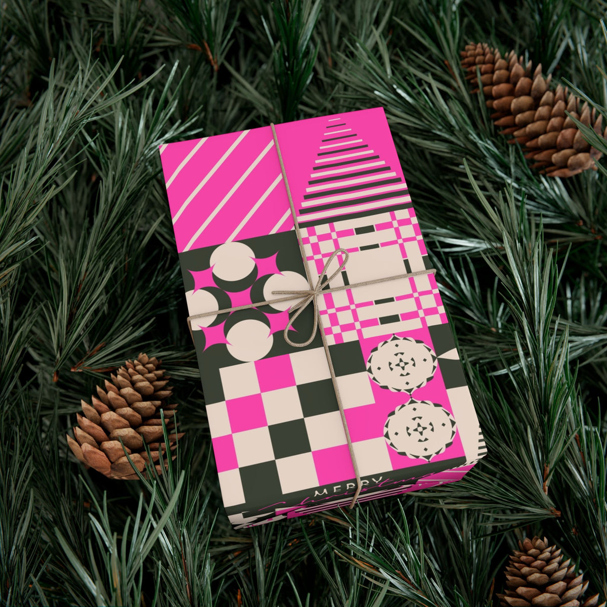 Christmas gift wrap paper in pink, black, and cream with patchwork plaid and ornaments