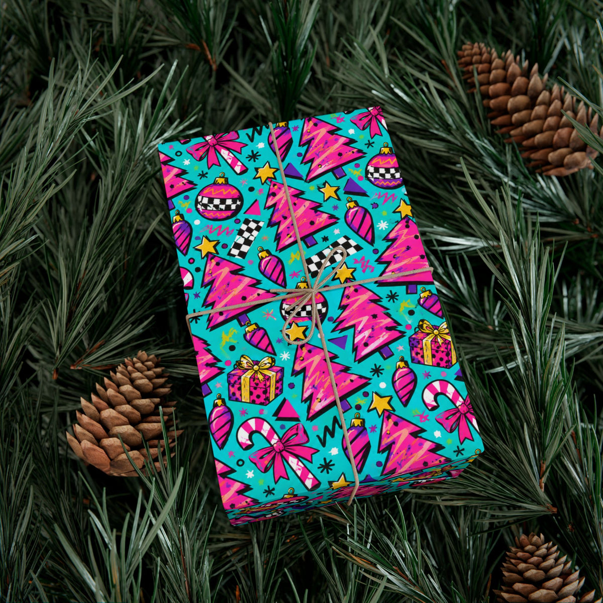 Colorful Christmas gift wrap paper sheet on pine branches with pinecone accents