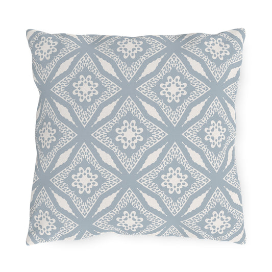 Square accent pillow in light blue featuring a white diamond quatrefoil pattern