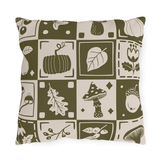 Rectangular decorative outdoor pillow in olive and cream with fall mushrooms, leaves, and acorns print