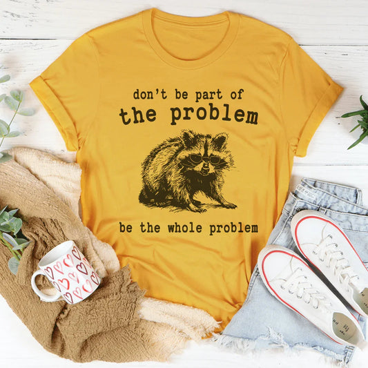 Mustard yellow T-shirt with raccoon graphic and 'don't be part of the problem' text