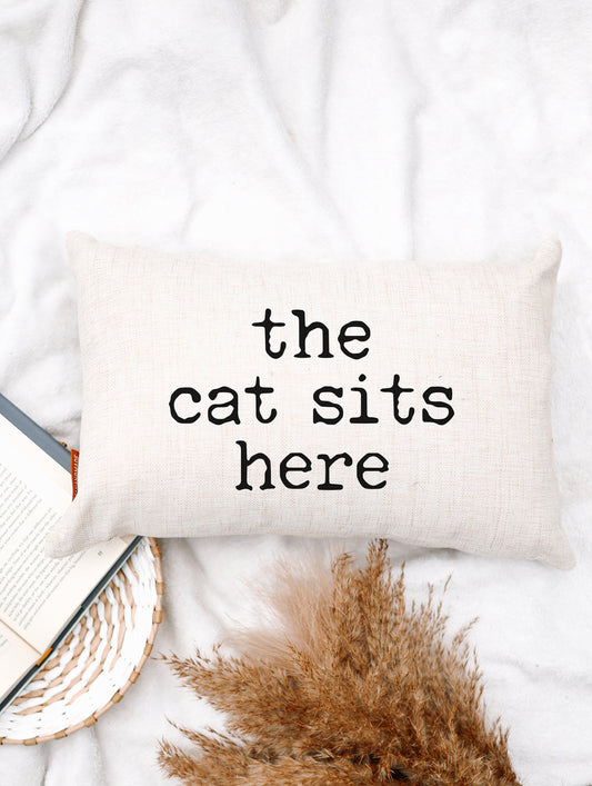 Off-white linen rectangular pillow embroidered 'the cat sits here'